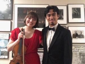 Two Orchestra members smiling at the camera